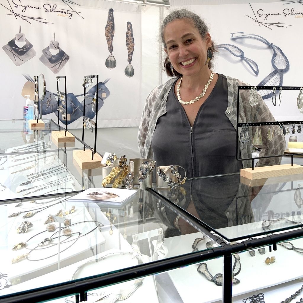 Suzanne Schwartz at her booth in a tradeshow