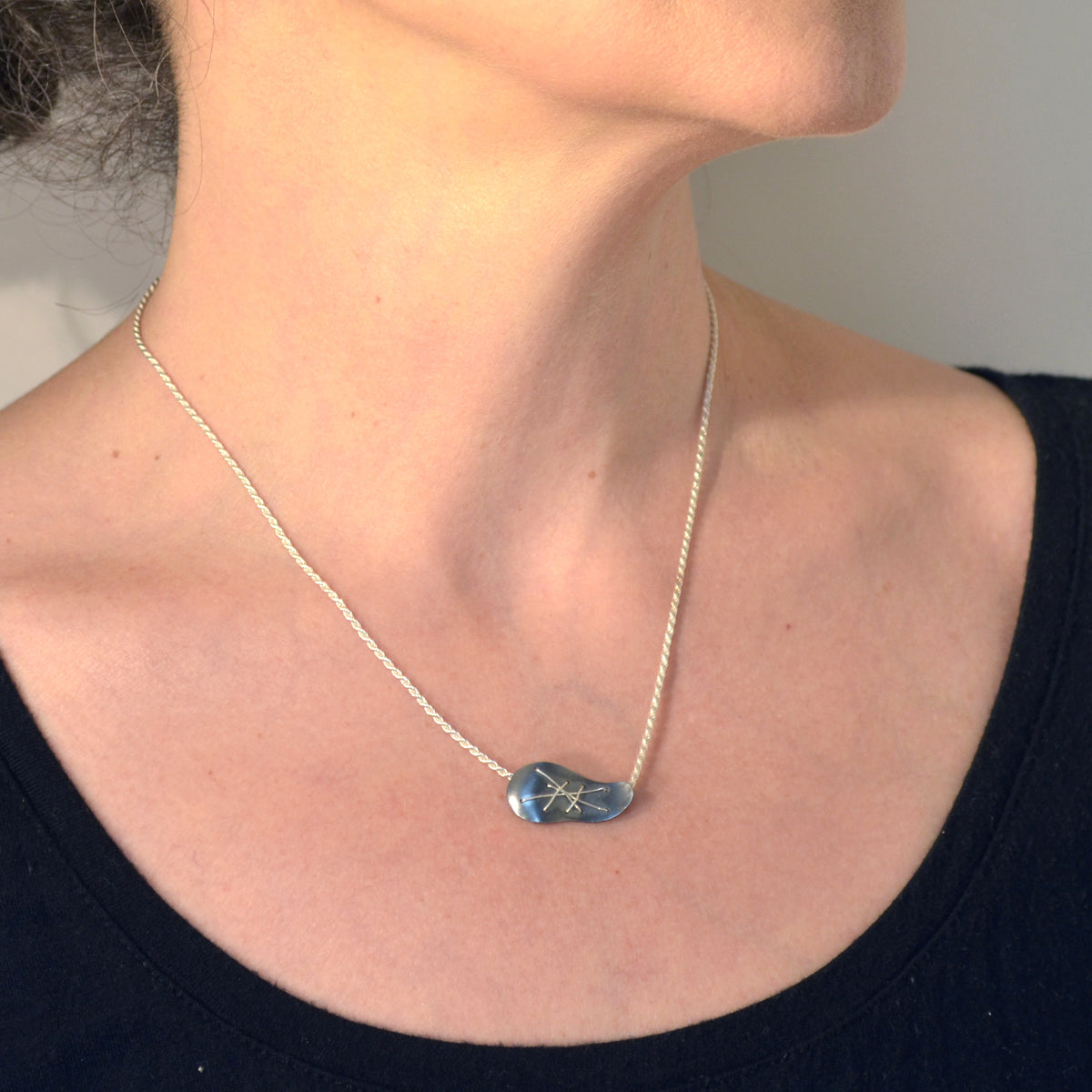 Suzanne Schwartz wearing Single Cascade Necklace pendant on chain - horizontal