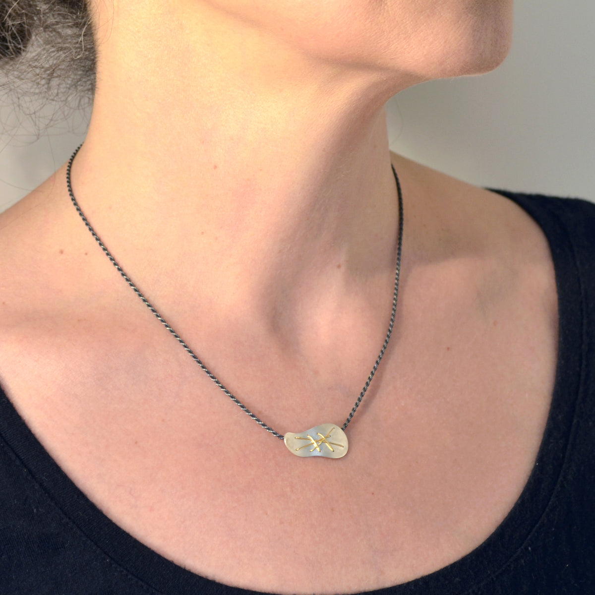 Suzanne Schwartz wearing Single Cascade Necklace pendant on chain - horizontal