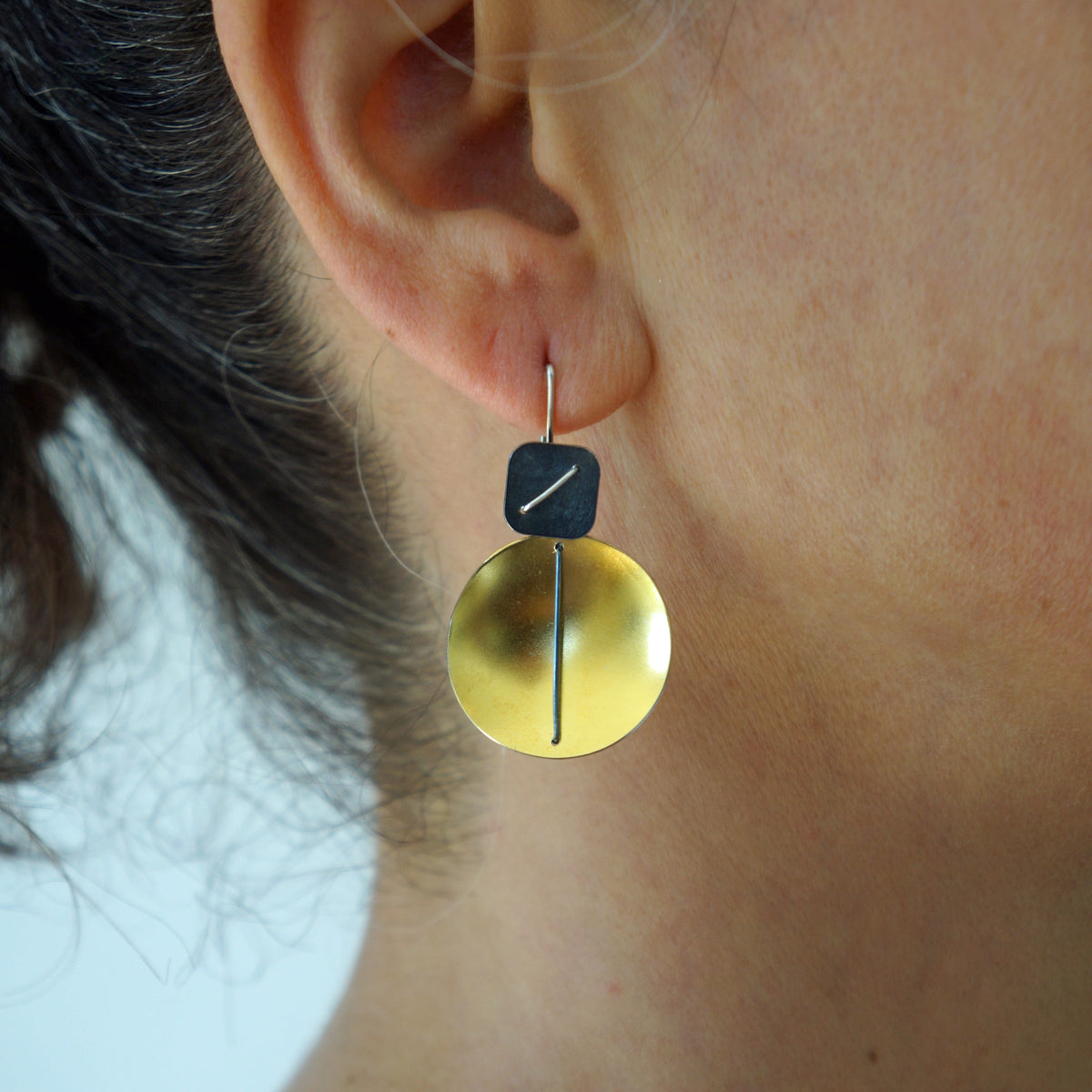 Suzanne Schwartz wearing Circle and Square Hanging Earring