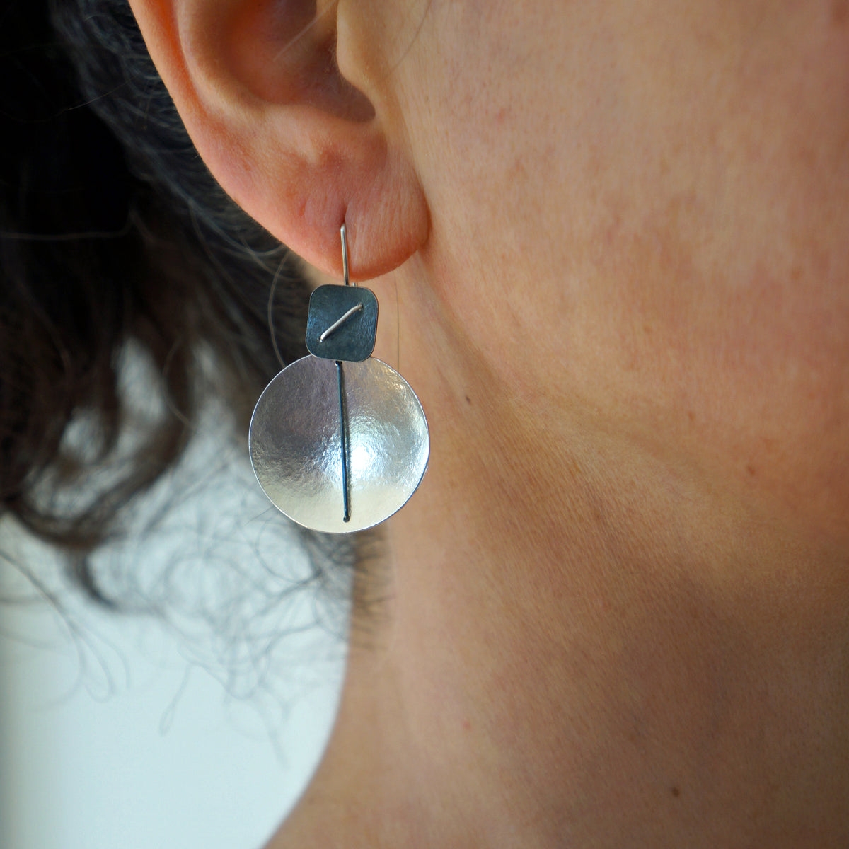 Suzanne Schwartz Wearing Circle and Square Hanging Earring
