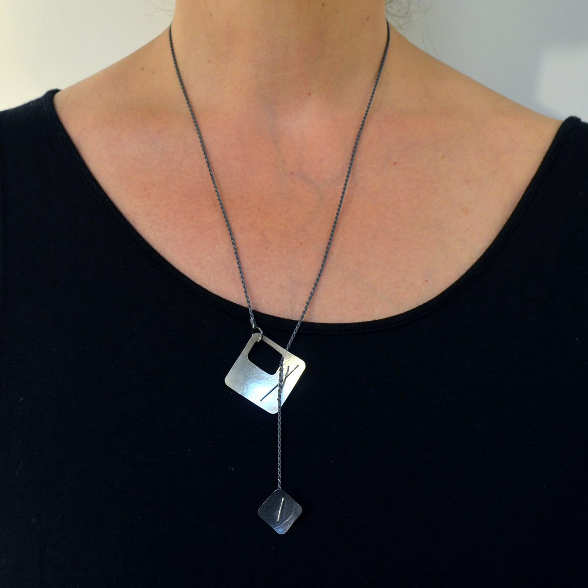 Suzanne Schwartz Wearing Two-Layered Stitched Square Necklace