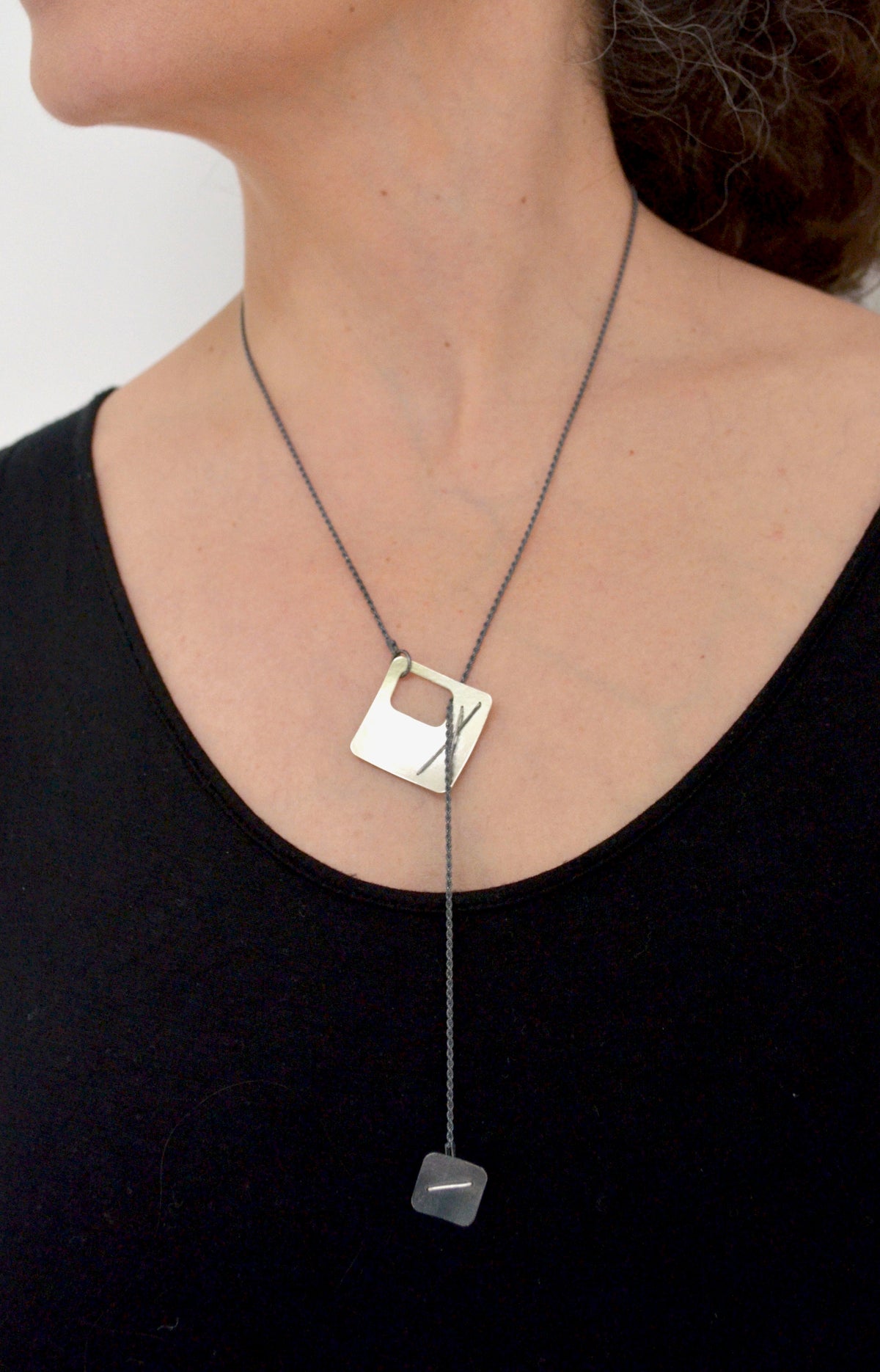 Suzanne Schwartz Wearing Two-Layered Stitched Square Necklace